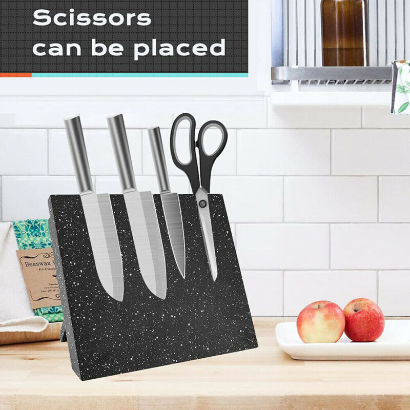 Countertop magnetic knife rack holding stainless steel kitchen knives